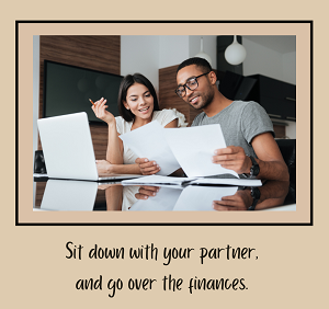 A couple sits together while reviewing paper documents and their laptop with the text “sit down with your partner and go over the finances” Learn how a couples therapist in Fair Oaks, CA can offer support with addressing couples’ finances.