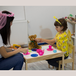 Woman and Child having a tea party in therapy in Roseville, CA | search for a child therapist to begin child therapy