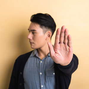Man putting hand up to say stop | what are boundaries and how to set them| get help setting boundaries with a therapist in Roseville, CA | Codependency counseling in Fair Oaks to set boundaries