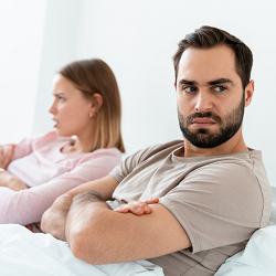 Couple looking away from each other in a fight | common relationship mistakes can be helped in marriage counseling in Fair Oaks, CA