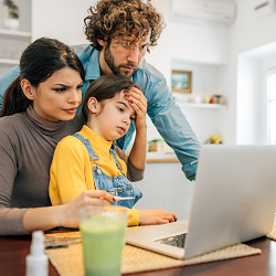 A family of three appear concerned as they look at a laptop. Learn more about therapy for children in Roseville, CA by searching “therapist for teens in Roseville, CA.” We offer teen therapy in California and other services.
