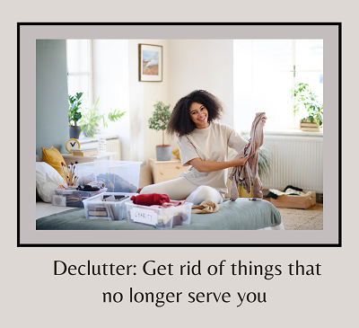 A woman smiles while organizing pesonal belongings on her bed and the text “declutter: get rid of things that no longer serve you.” Learn more about the support a therapist in Fair Oaks, CA can offer by trying new things and searching “counseling nea
