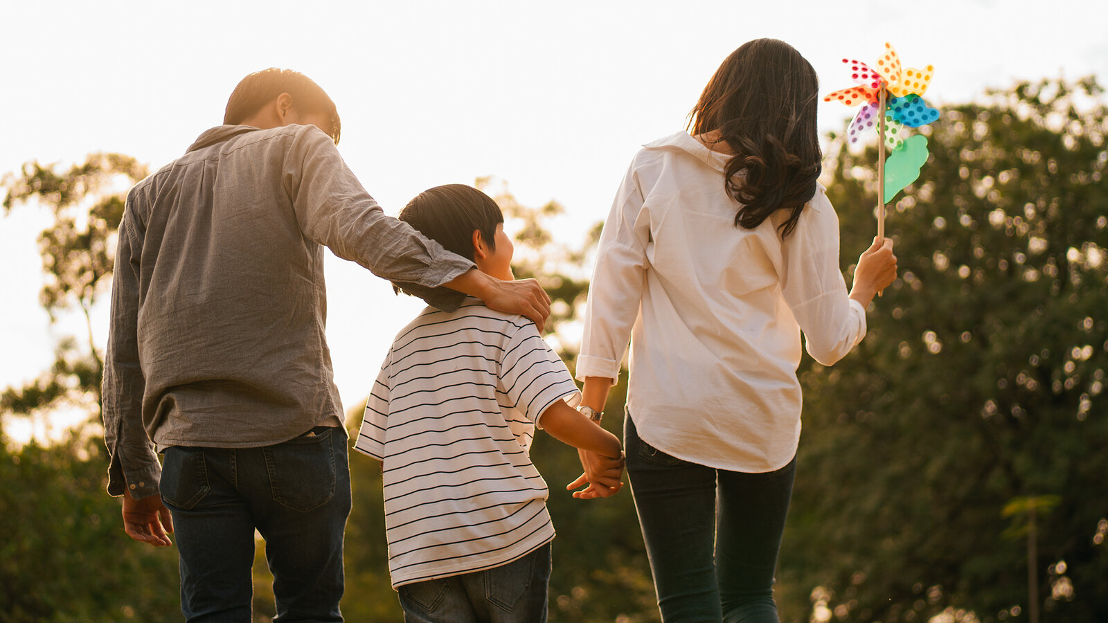 photo of an Asian family outdoors walking in the park after family therapy in Fair Oaks, CA and family therapy in Roseville, CA at The Relationship Therapy Center