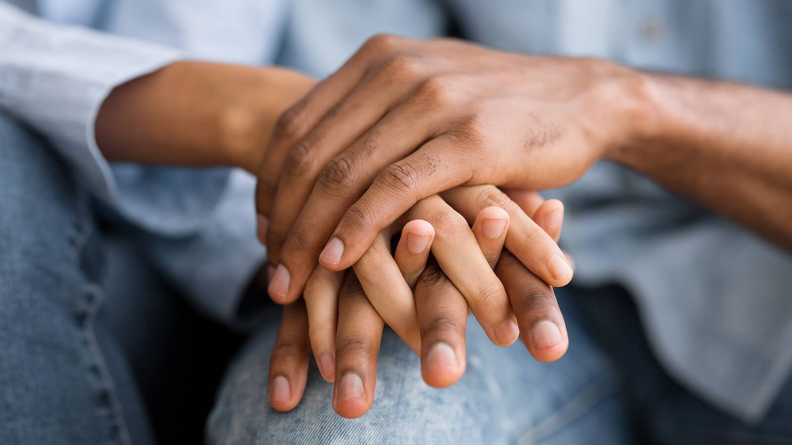 A close-up of a couple holding hands. This represents the bond a marriage counselor in California can cultivate. Learn more by searching marriage counseling near me to learn more about online marriage counseling in California today! 95678