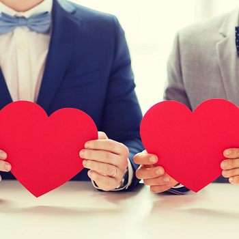 Couple holds red hearts representing the love they feel after premarital counseling in Fair Oaks, CA with the Relationship Therapy Center who also offers premarital counseling in Roseville, CA and online therapy in California