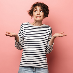 A woman shrugs with a confused expression against a blank wall. This represents the unique challenges codependent counseling in Fair Oaks, CA can address. Contact a marriage counselor in California to learn more about counseling in Roseville, CA