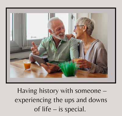 A smiling couple sits at a kitchen table while talking. The text under sells “having history with someone - experiencing the ups and downs of life - is special”. Learn how a couples therapist in California can offer support with navigating divorce wi