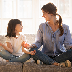 A mother and child smile at one another as they sit in a yoga pose. An anxiety therapist in Fair Oaks, CA can offer strategies to cope with anxiety. Learn more about anxiety treatment in Roseville, CA today. 95678