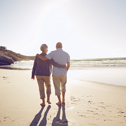 A middle aged couple walk together along a sunny beach. A therapist in Fair Oaks, CA can help you in overcoming relationship issues including intimacy. Learn more about sex therapy in Sacramento, CA and other services by searching "counseling for ros