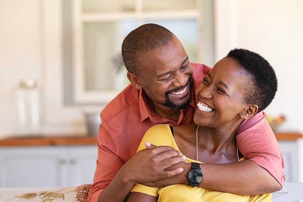 Mature African American Couple smiling and hugging after couples therapy or Couples counseling online and in the Roseville, CA area 95678 and Fair Oaks 95628 at The Relationship Therapy Center