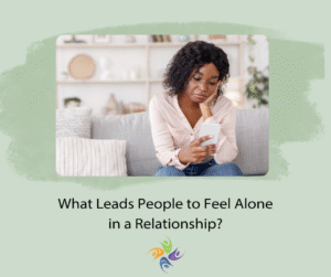 What Leads People to Feel Alone in a Relationship? Image of a woman sitting on a couch alone looking at her phone. For couples counseling contact The Relationship Therapy Center in Roseville and Fair Oaks California.
